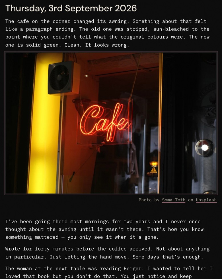 Thursday's page with a photograph between the first and second paragraphs — an amber neon café sign against a dark window — with its Unsplash credit beneath.